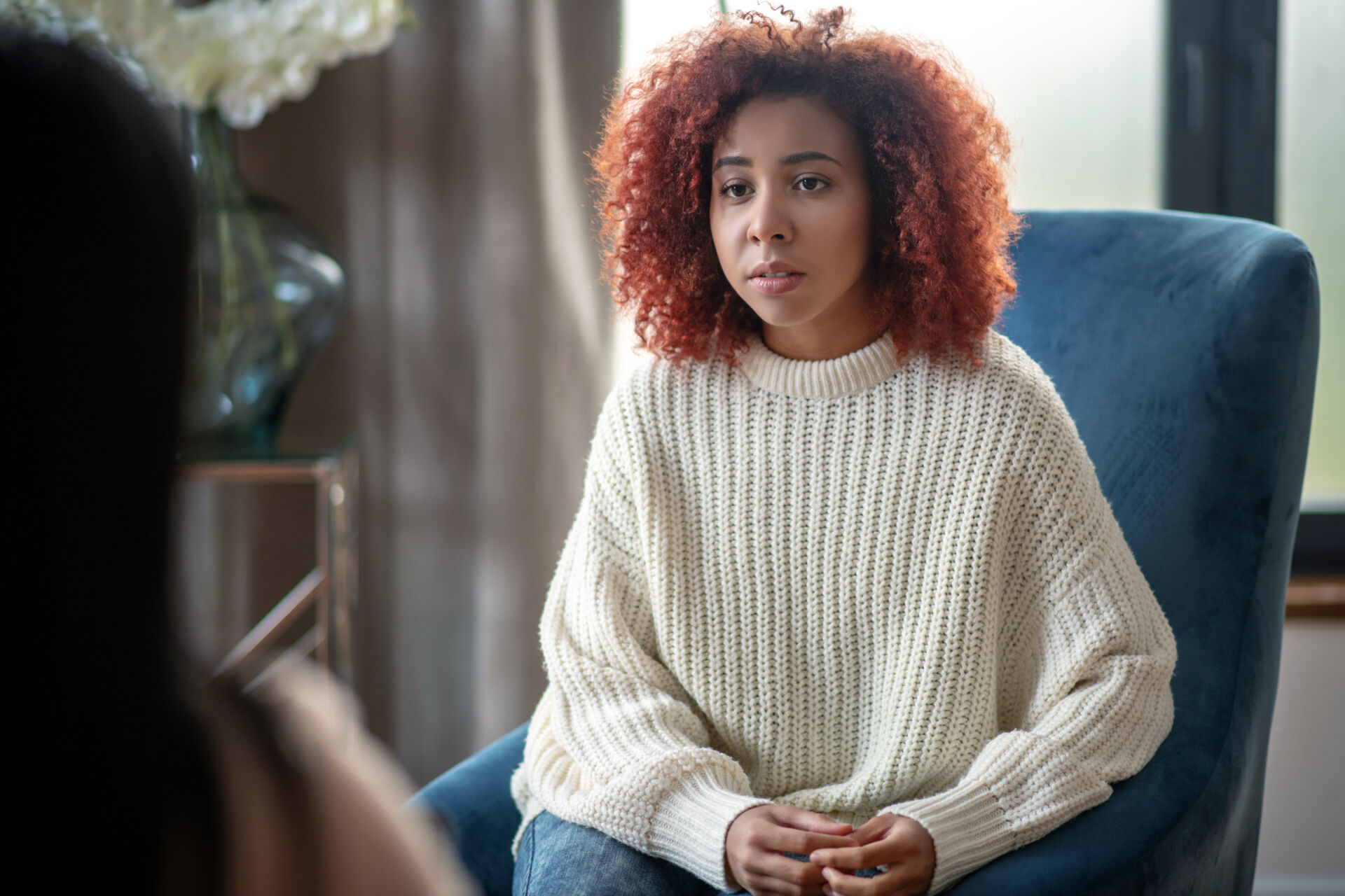 Listening to psychologist. Young dark-eyed woman feeling emotional while listening to psychologist